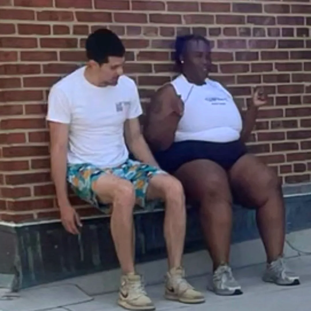 Trainer and client resting after an outdoor workout