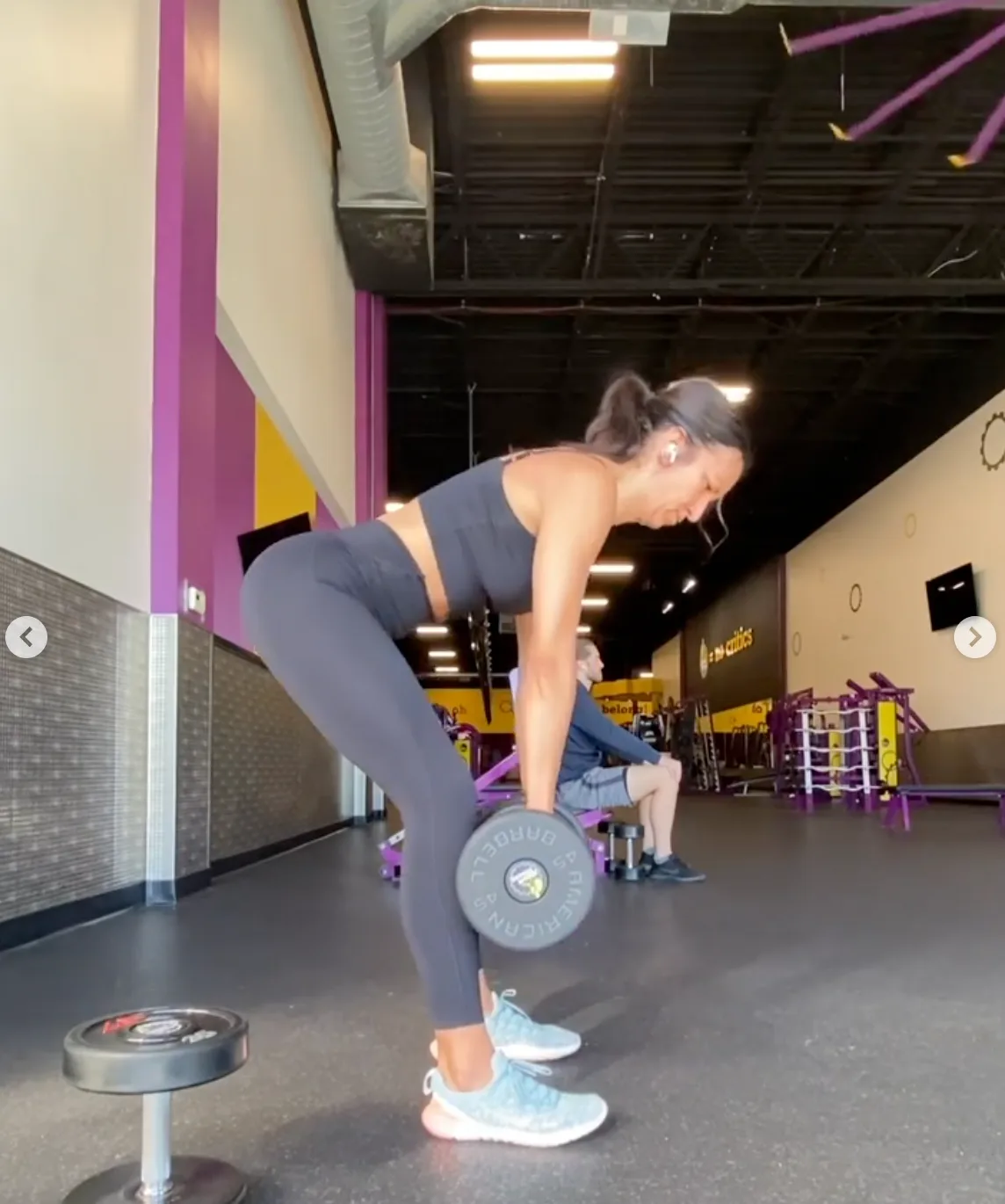 Client practicing a dumbbell deadlift