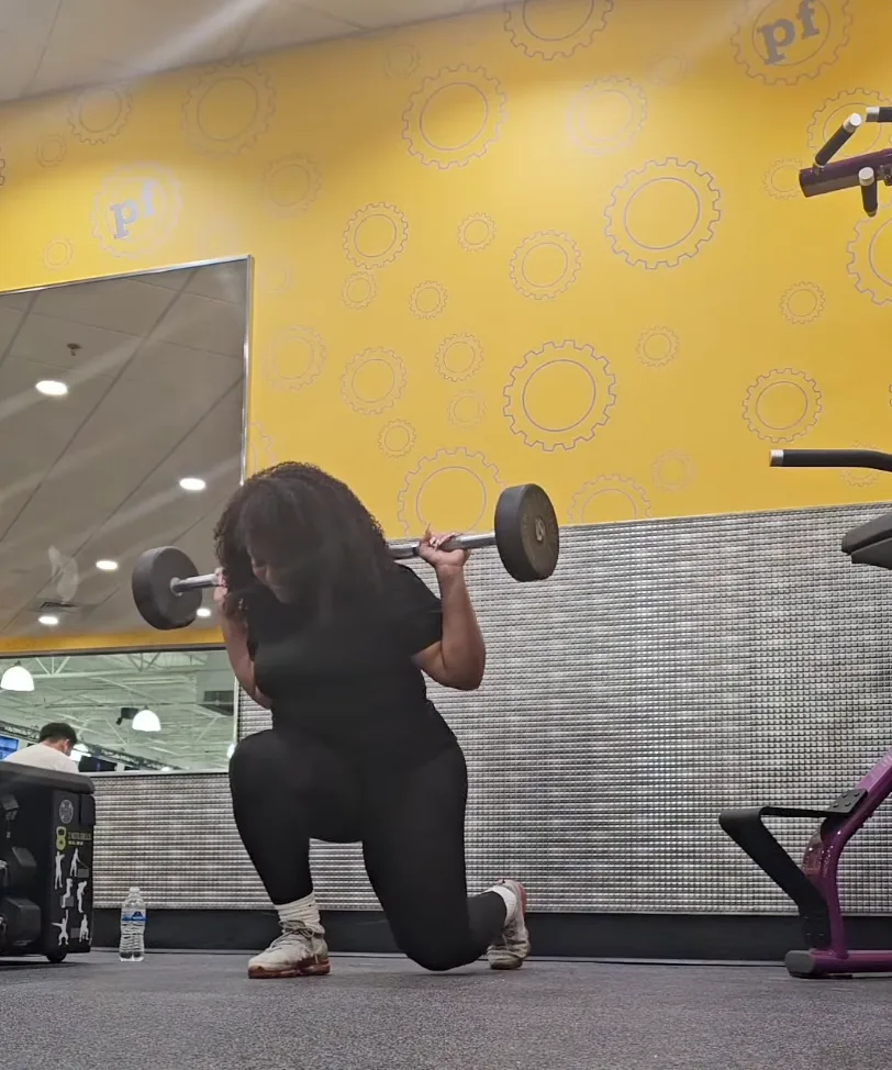 Client performing a weighted reverse lunge